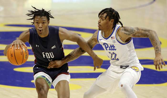 Fairleigh Dickinson Knights forward Sean Moore (11) handles the ball against Pittsburgh Panthers guard Nike Sibande (22) during the second half at the Petersen Events Center. Pittsburgh won 83-61.
